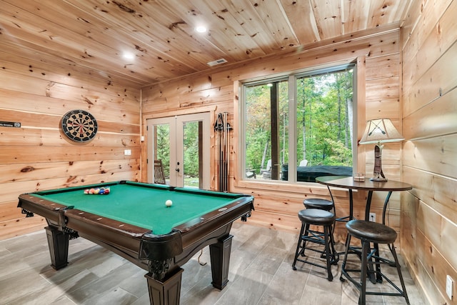 rec room with french doors, wooden walls, light hardwood / wood-style flooring, wooden ceiling, and pool table