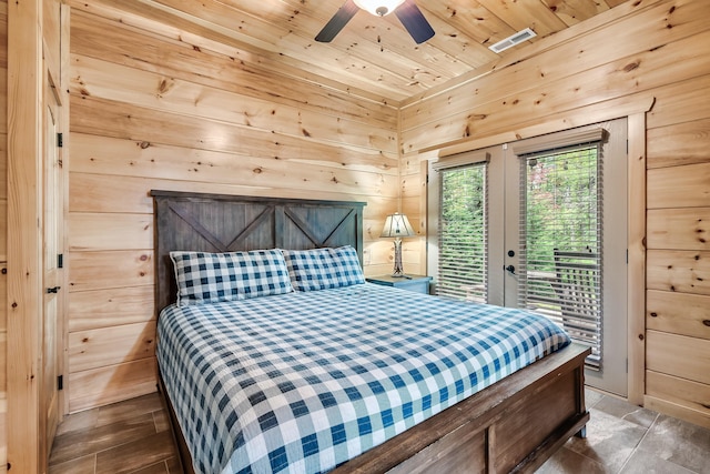 bedroom with access to exterior, wooden ceiling, ceiling fan, and wooden walls