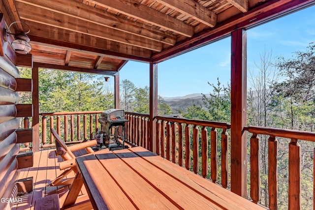 wooden terrace with a grill