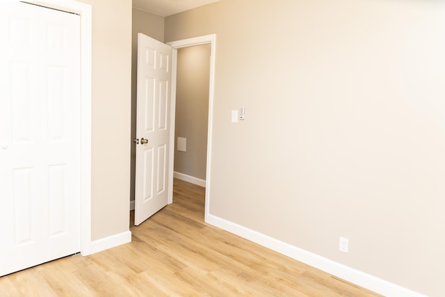 unfurnished bedroom featuring a closet and light hardwood / wood-style flooring