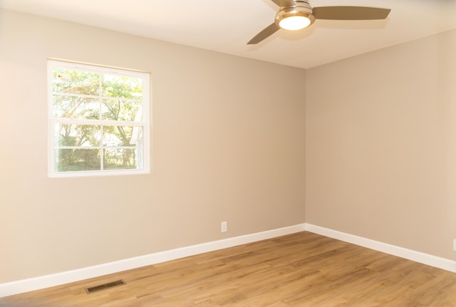 empty room featuring wood-type flooring and ceiling fan