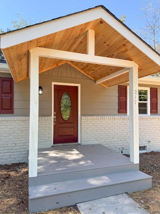 view of exterior entry featuring a porch