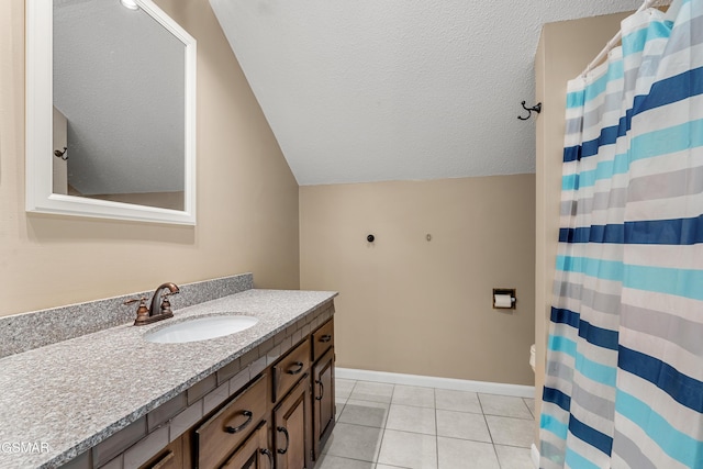 bathroom with lofted ceiling, vanity, tile patterned floors, and a textured ceiling