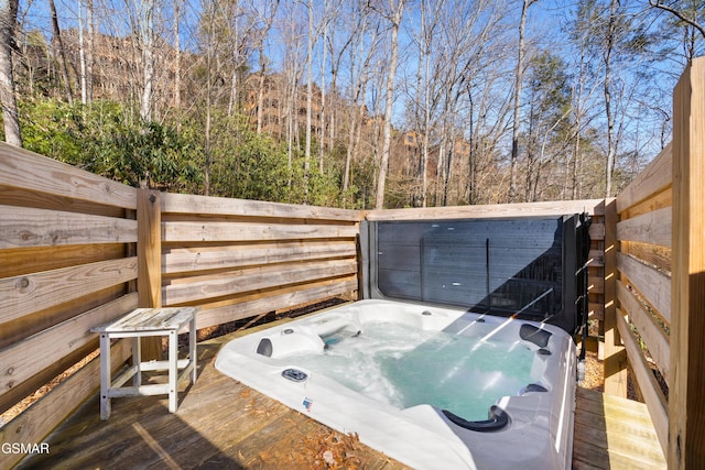 wooden deck featuring a hot tub