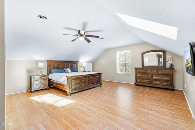 bedroom with light hardwood / wood-style flooring and lofted ceiling with skylight