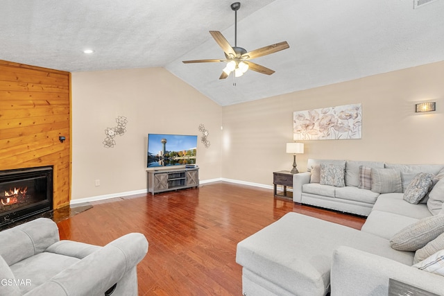 living room with lofted ceiling, wood-type flooring, and ceiling fan