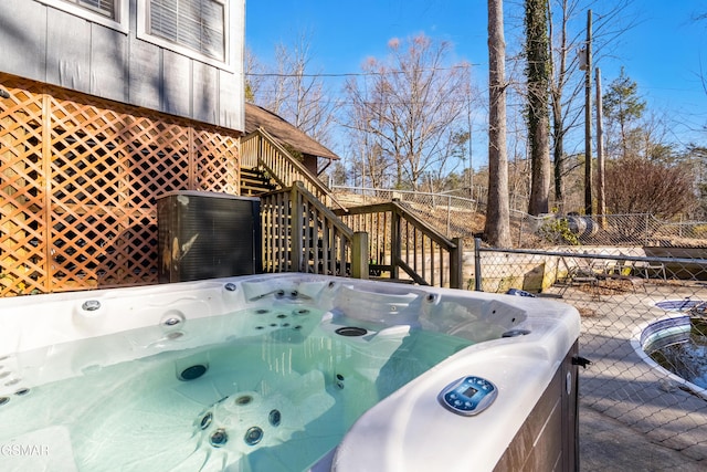 wooden deck with a hot tub