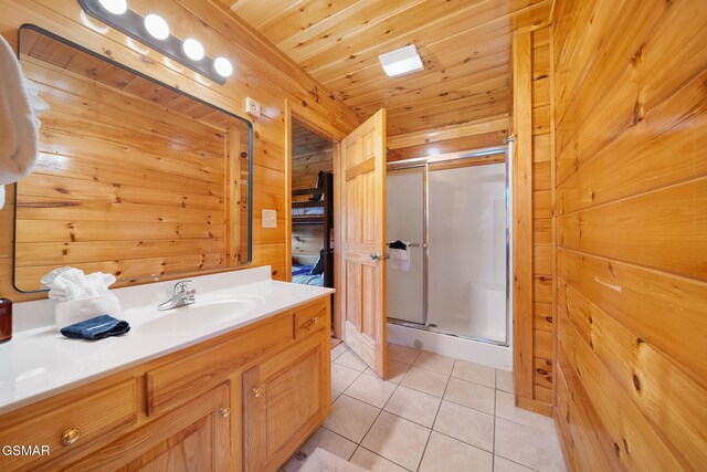 368 Oak Lake Dr, Sevierville, TN 37876 - full bath featuring a shower stall, tile patterned floors, vanity, and wooden walls