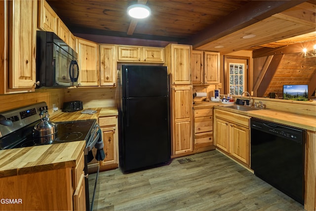 kitchen featuring butcher block counters, sink, light hardwood / wood-style flooring, black appliances, and wood ceiling