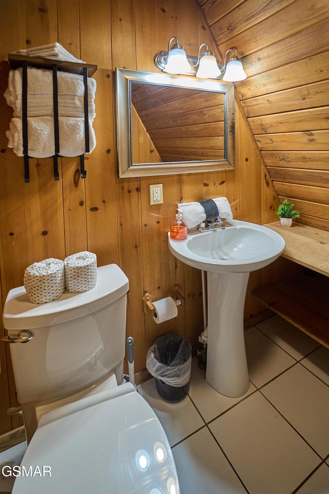 bathroom featuring wooden ceiling, tile patterned floors, wood walls, vaulted ceiling, and toilet