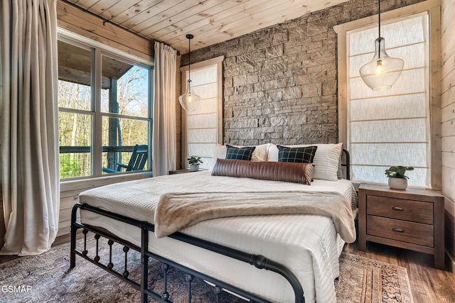 bedroom featuring dark hardwood / wood-style floors, wooden ceiling, and wood walls