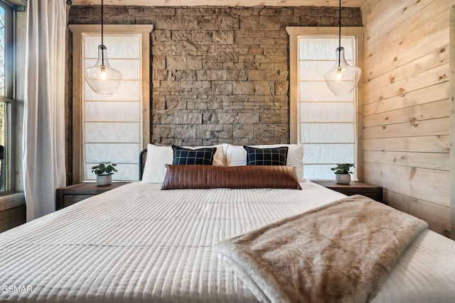 bedroom featuring wooden walls