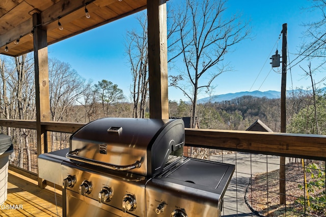 deck featuring a mountain view and area for grilling