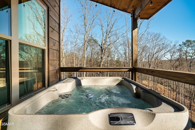 wooden terrace with a hot tub