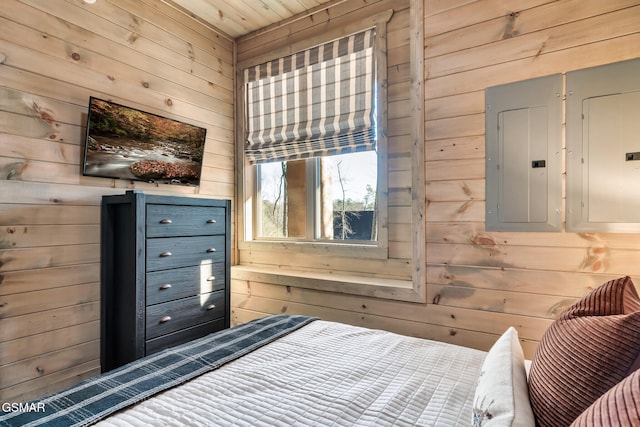 bedroom featuring electric panel, wooden walls, and wood ceiling