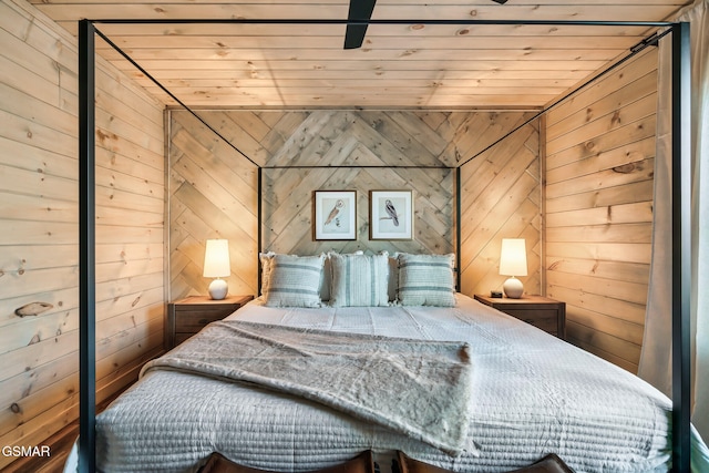 bedroom with wooden walls and wood ceiling