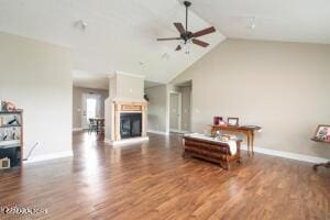 2039 James Rd, Sevierville, TN 37876 - living area with a ceiling fan, wood finished floors, baseboards, a fireplace, and high vaulted ceiling