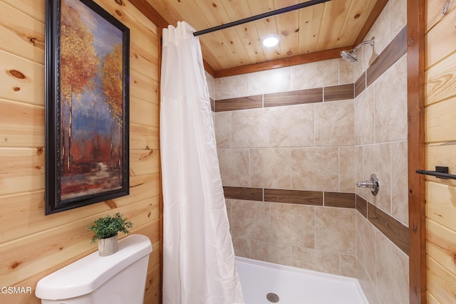 bathroom featuring curtained shower, wooden walls, wood ceiling, and toilet