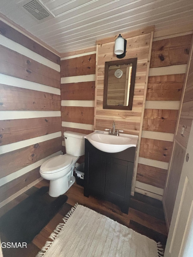 864 Fugate Rd, Del Rio, TN 37727 - half bathroom featuring wood walls, vanity, and wood finished floors