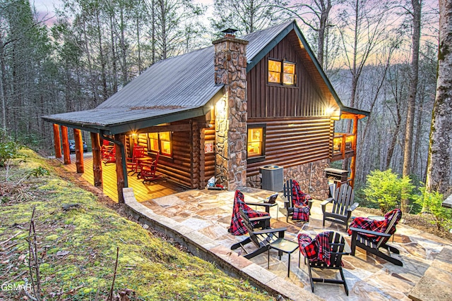 3115 E E Pkwy, Gatlinburg, TN 37738 - back of property with metal roof, log exterior, central AC unit, and a chimney