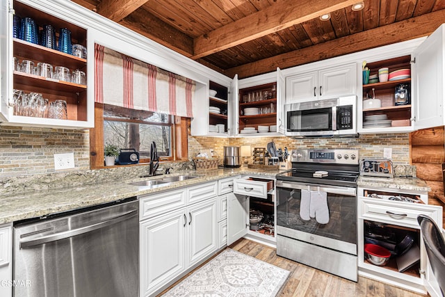 3115 E E Pkwy, Gatlinburg, TN 37738 - kitchen featuring stainless steel appliances, light stone countertops, white cabinetry, and open shelves