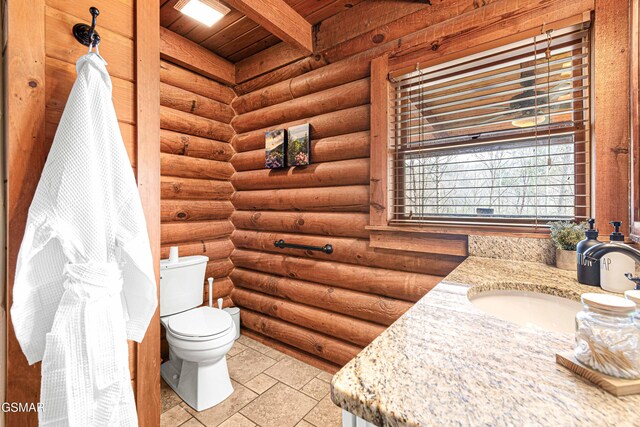 3115 E E Pkwy, Gatlinburg, TN 37738 - bathroom with beamed ceiling, stone tile flooring, vanity, and toilet