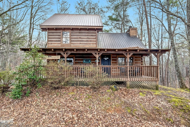 view of front of home with metal roof and a chimney