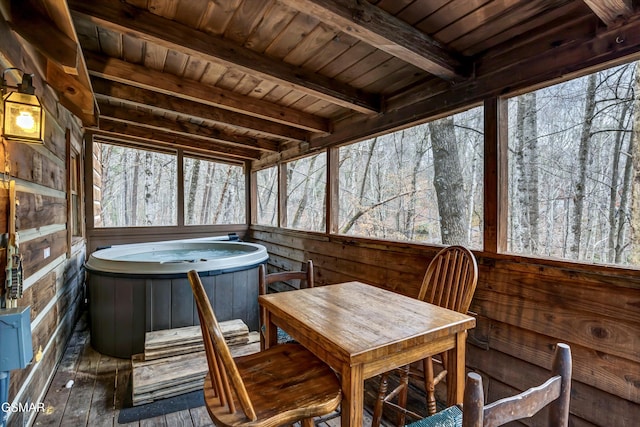 sunroom / solarium with beam ceiling, wooden ceiling, and a hot tub