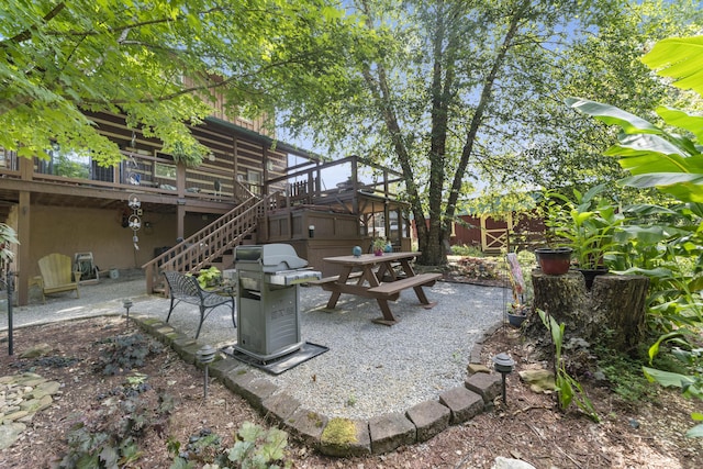 view of patio with area for grilling and a deck