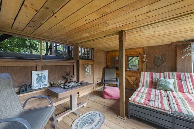 interior space featuring light hardwood / wood-style floors, wooden ceiling, and wooden walls