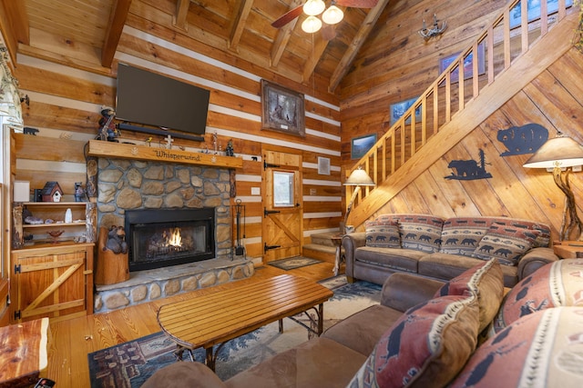 living room featuring beam ceiling, wood ceiling, and a fireplace