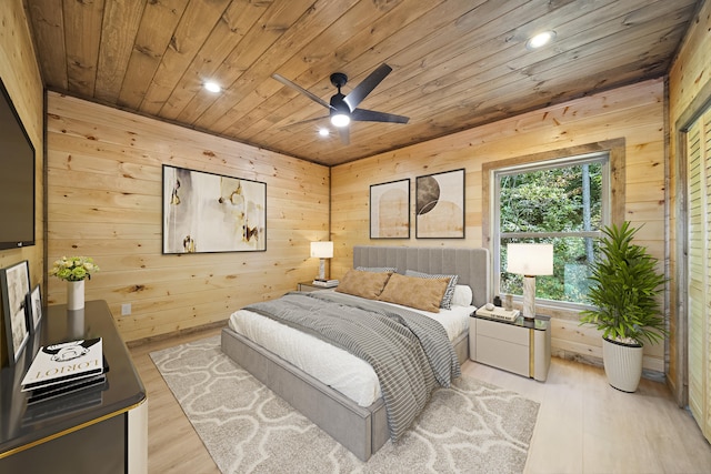 bedroom featuring wood walls, ceiling fan, wooden ceiling, and light hardwood / wood-style floors