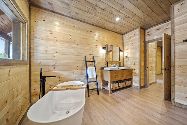 bathroom with a tub to relax in, wood walls, wood ceiling, and hardwood / wood-style flooring