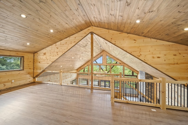 additional living space with hardwood / wood-style floors, lofted ceiling, wood ceiling, and wooden walls