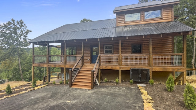 cabin with a patio and a wooden deck