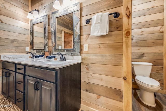 2862 Indigo Ln, Sevierville, TN 37862 - full bathroom featuring wooden walls, toilet, and double vanity