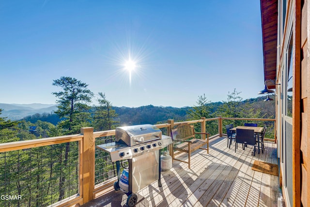 2862 Indigo Ln, Sevierville, TN 37862 - wooden deck featuring area for grilling, a mountain view, and outdoor dining area