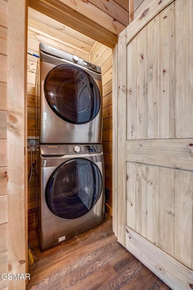 2862 Indigo Ln, Sevierville, TN 37862 - washroom featuring stacked washer and clothes dryer, wood walls, and wood finished floors