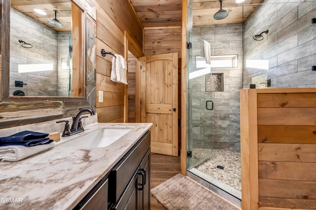 2862 Indigo Ln, Sevierville, TN 37862 - full bathroom featuring a shower stall, wooden ceiling, wood walls, wood finished floors, and vanity