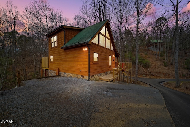 property exterior at dusk with a deck