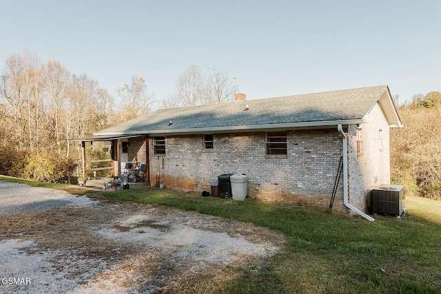 back of property featuring central AC