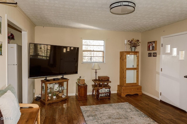 interior space with a textured ceiling and dark hardwood / wood-style floors