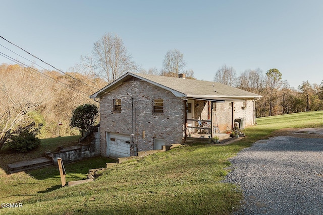 view of home's exterior with a garage and a yard