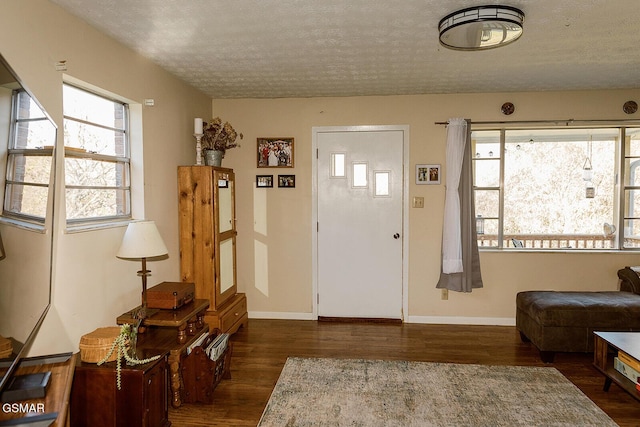 entrance foyer featuring dark hardwood / wood-style floors and a textured ceiling