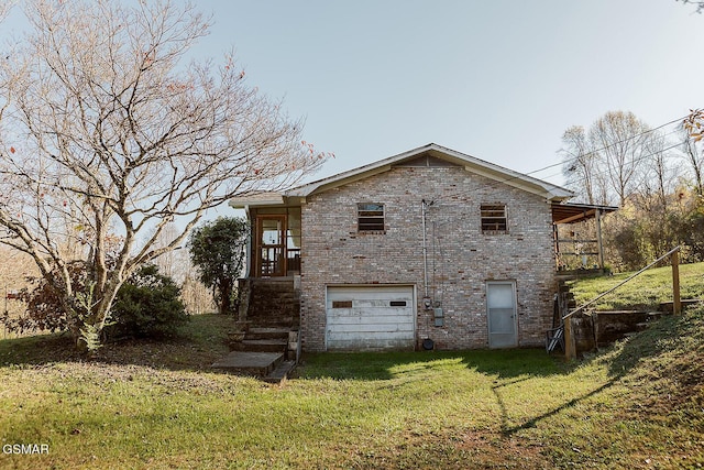 back of property featuring a yard and a garage