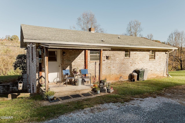 rear view of house with a yard