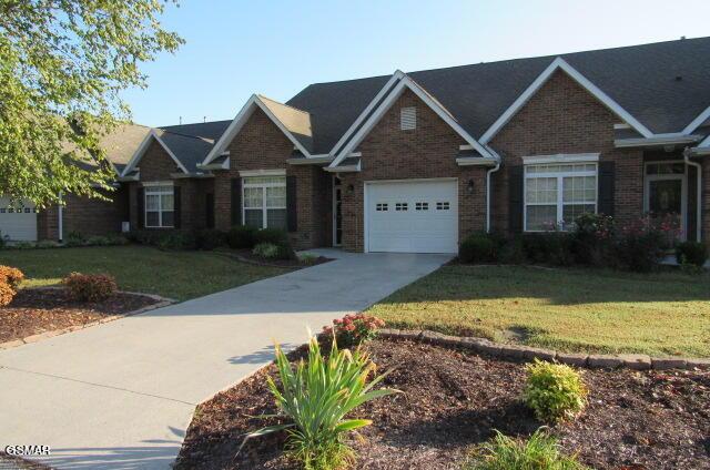 view of front of property featuring a garage and a front lawn