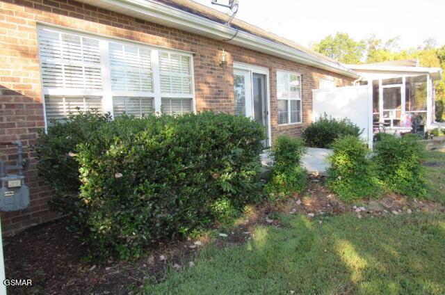 view of side of home featuring a sunroom