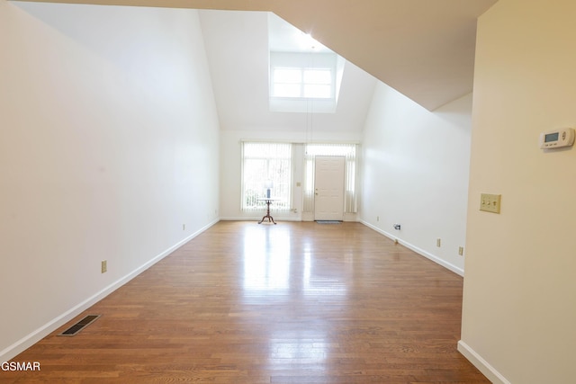 interior space featuring high vaulted ceiling and hardwood / wood-style floors