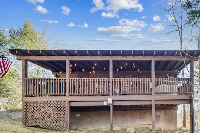 rear view of property featuring a deck